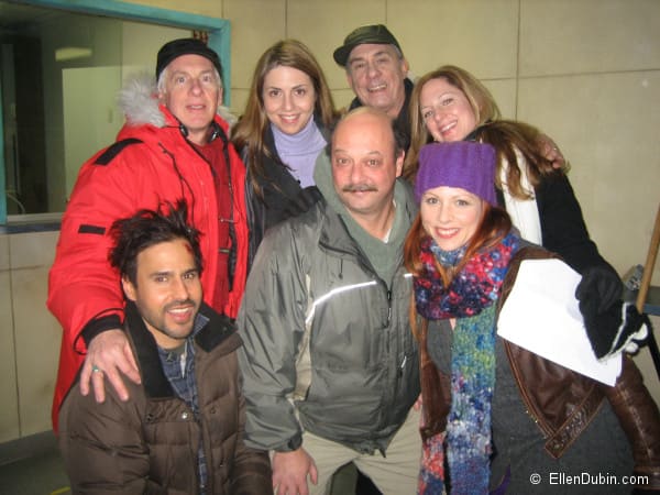 A cast photo of the BRAVOFACT short film LOST AND FOUND. Ellen Dubin as Lise, Marcello Cabezas as Andy (kneeling), Michael Kennedy, Director (in red parka), Phil Williams as Pete (with moustache), Melissa Jane Shaw as Beth (with purple hat), Alex Mcnally, writer (blonde gal), James Zaza, Taxi Driver (green cap)